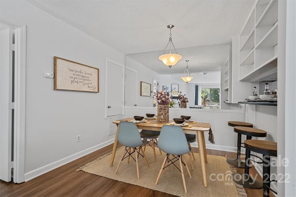 1606 Sharon Road West Charlotte, NC 28210 - Photo 4 of 19 a view of a dining room with furniture and wooden floor