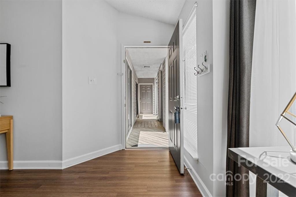 1606 Sharon Road West Charlotte, NC 28210 - Photo 9 of 19 a view of a hallway with wooden floor and staircase