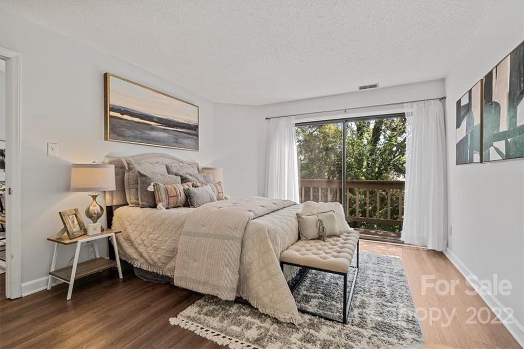 1606 Sharon Road West Charlotte, NC 28210 - Photo 10 of 19 a bedroom with a bed and wooden floor