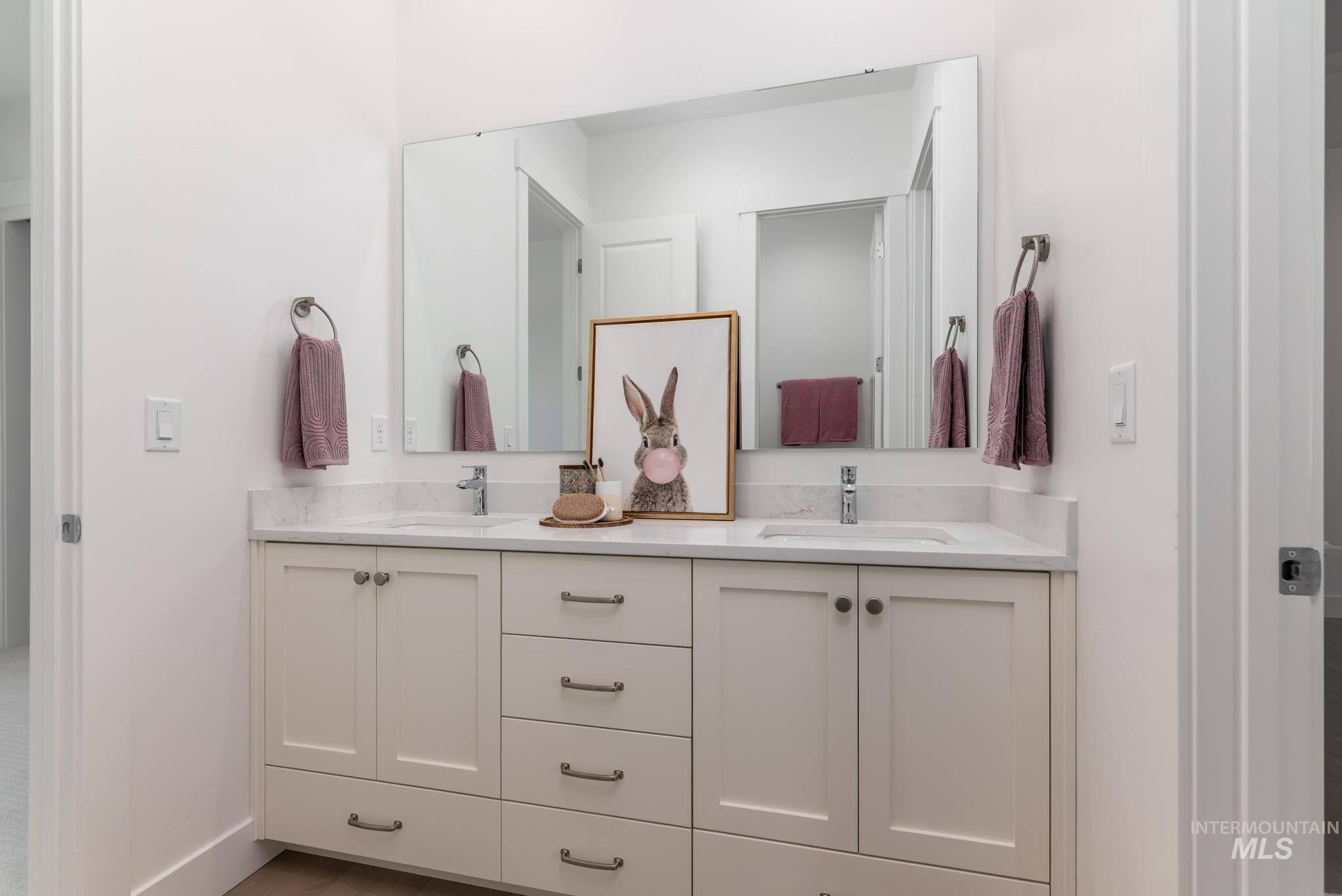 8501 South Country Wind Avenue Meridian, ID 83642 - Photo 23 of 39 Dual-sink vanity with a light-toned countertop and chrome fixtures