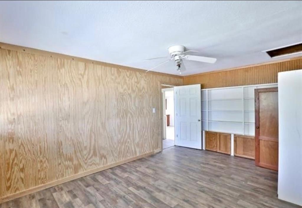 10971 West Lake Road Abilene, TX 79601 - Photo 5 of 17 a view of an empty room with a window and wooden floor