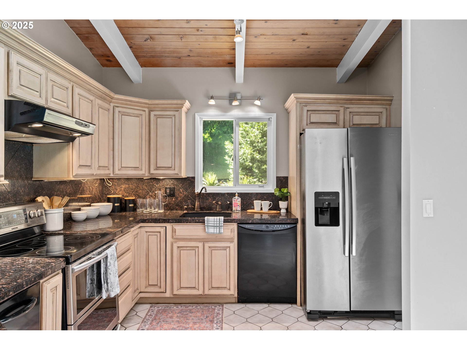 32314 Southeast Oxbow Drive Gresham, OR 97080 - Photo 17 of 40 a kitchen with stainless steel appliances granite countertop a refrigerator a sink a stove and white cabinets