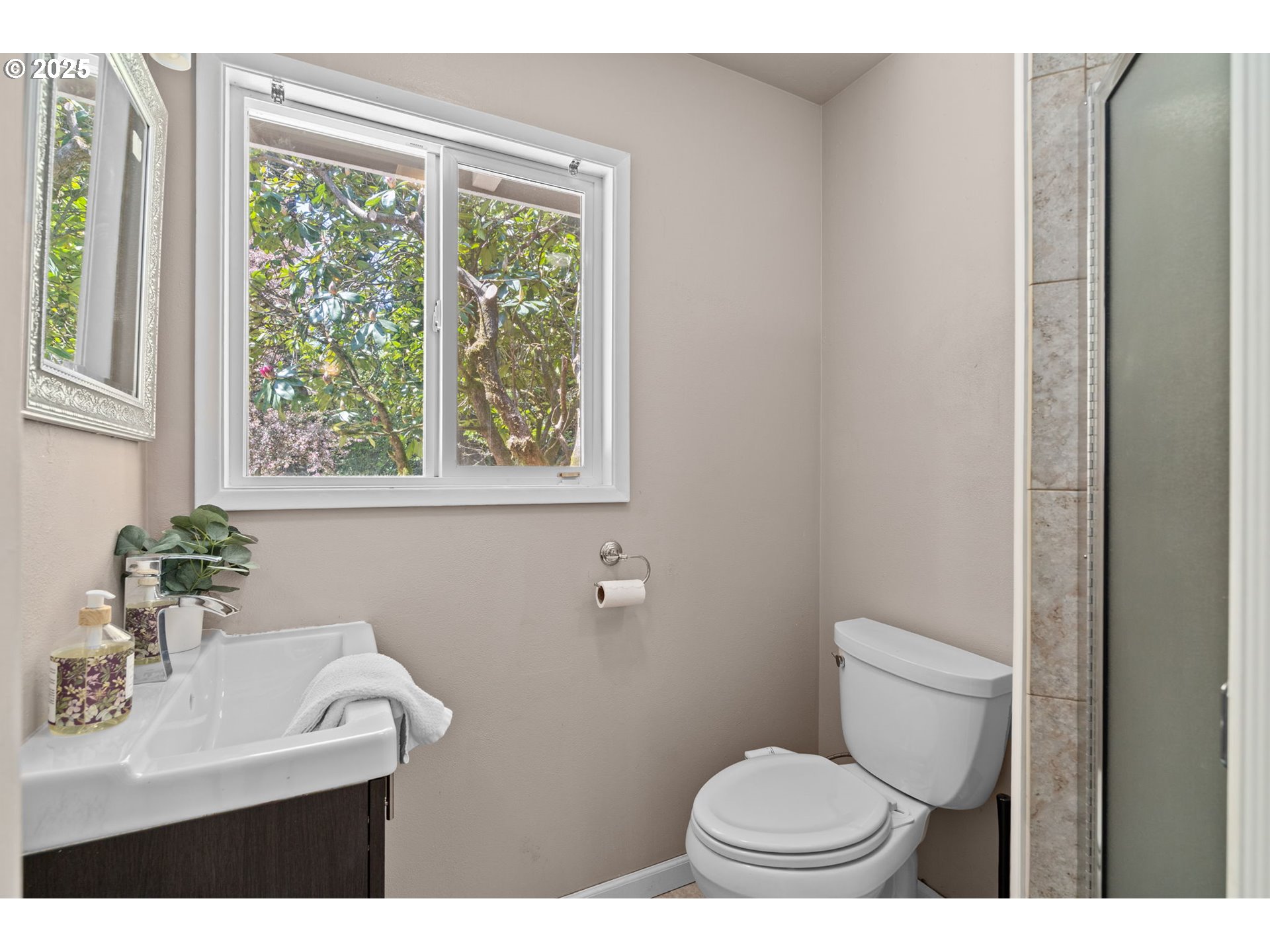 32314 Southeast Oxbow Drive Gresham, OR 97080 - Photo 21 of 40 a bathroom with a sink a toilet a window and mirror