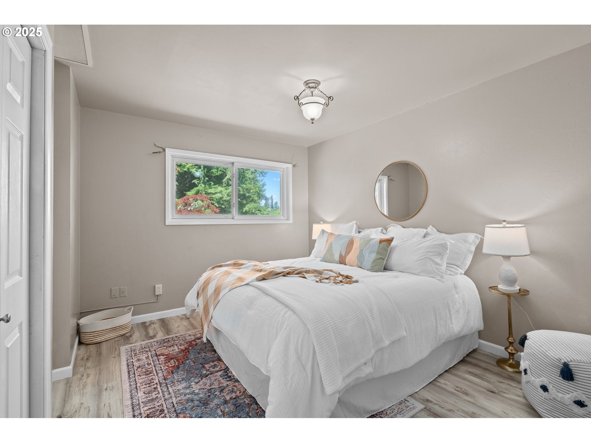32314 Southeast Oxbow Drive Gresham, OR 97080 - Photo 23 of 40 a bedroom with a large bed and a chandelier