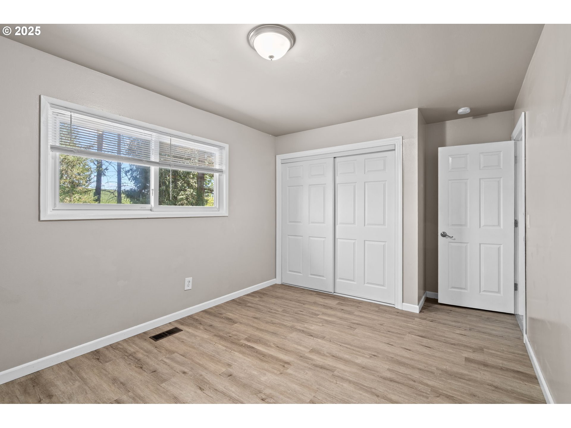 32314 Southeast Oxbow Drive Gresham, OR 97080 - Photo 26 of 40 a view of an empty room with wooden floor and a window