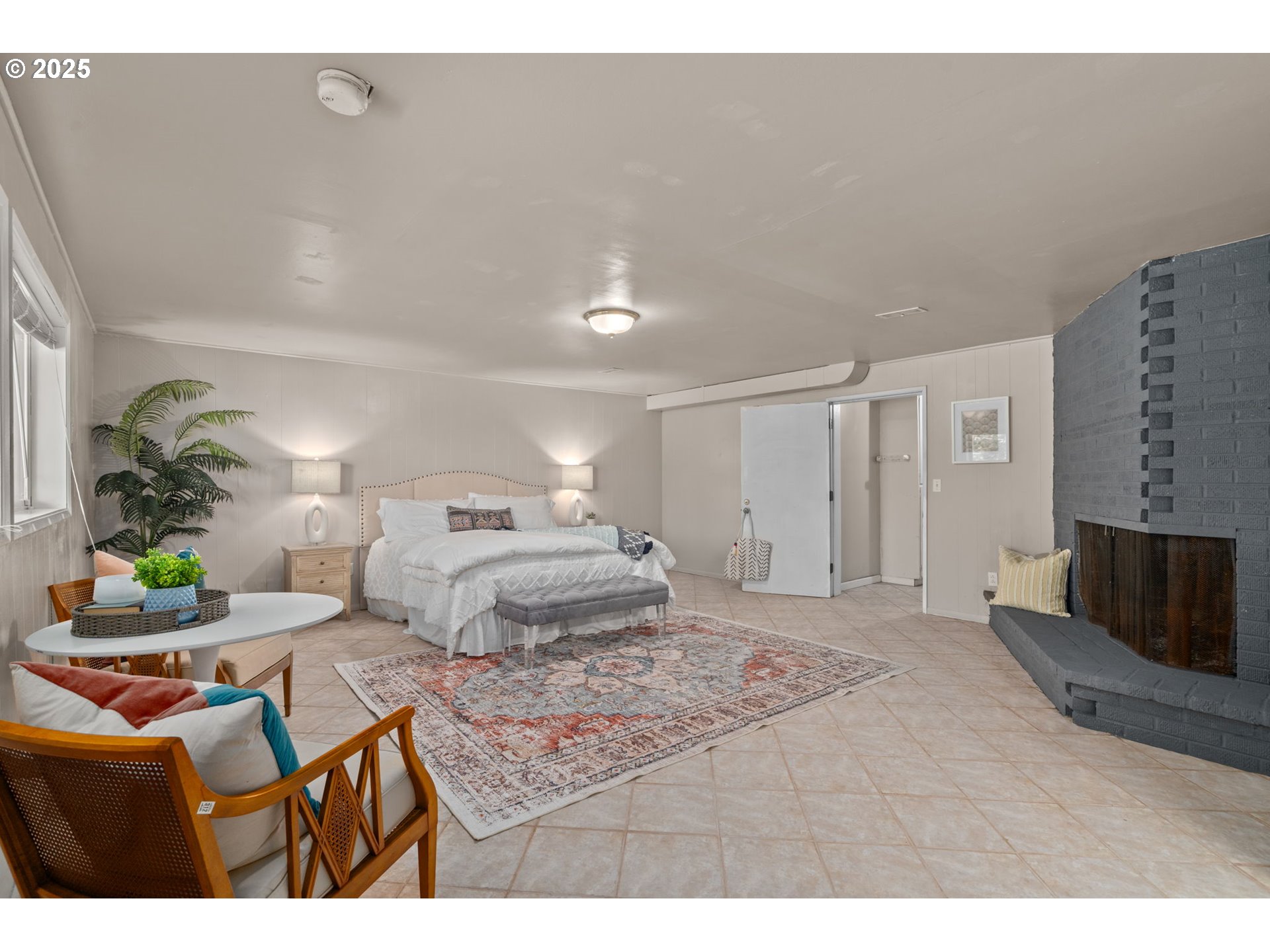 32314 Southeast Oxbow Drive Gresham, OR 97080 - Photo 29 of 40 a bedroom with a bed a couch and a flat screen tv