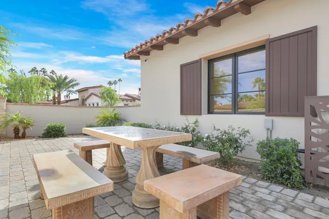 a living room with furniture a chandelier and a fireplace