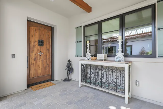 a dining room with furniture a chandelier and window