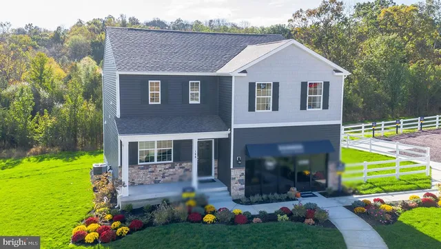 a front view of a house with a yard table and chairs