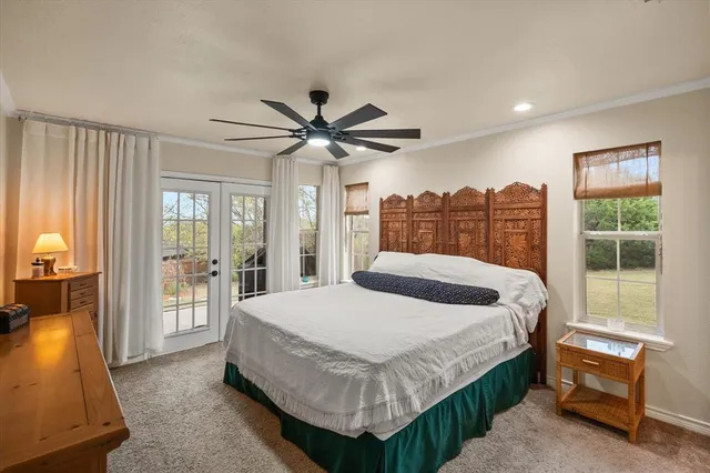 a bedroom with a large bed and a large window