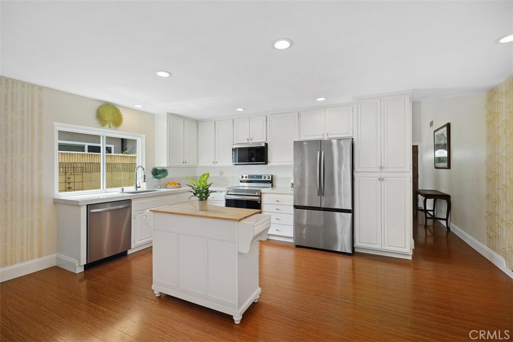 11596 Lakia Drive Cypress, CA 90630 - Photo 13 of 46 a kitchen with a refrigerator and a stove top oven