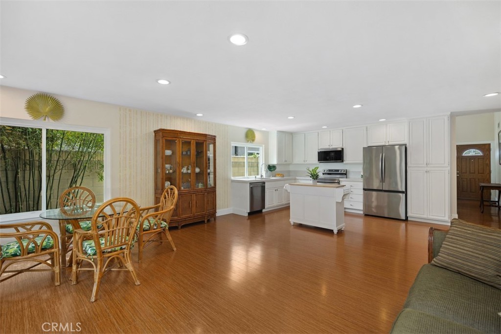 11596 Lakia Drive Cypress, CA 90630 - Photo 18 of 46 a view of kitchen with dining table chairs refrigerator and wooden floor