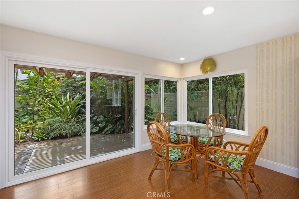11596 Lakia Drive Cypress, CA 90630 - Photo 19 of 46 a view of a dining room with furniture large windows and wooden floor