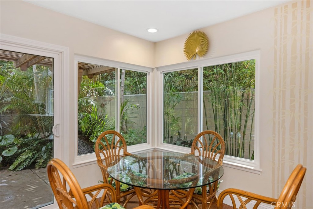 11596 Lakia Drive Cypress, CA 90630 - Photo 20 of 46 a dining room with furniture a chandelier and glass door
