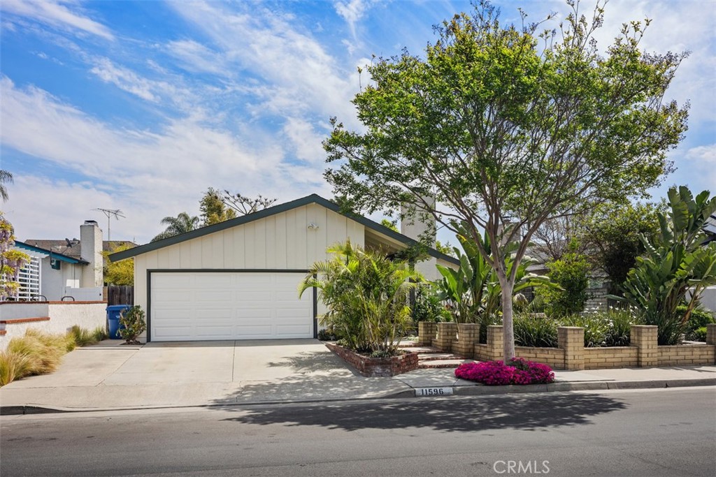 11596 Lakia Drive Cypress, CA 90630 - Photo 2 of 46 a front view of a house with a yard