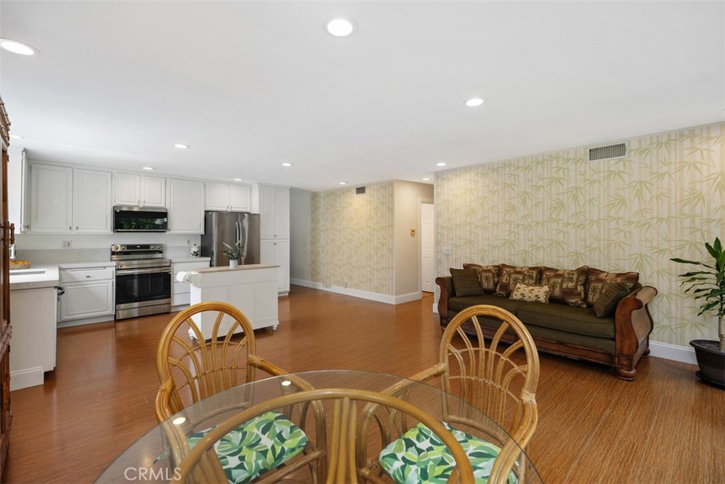 11596 Lakia Drive Cypress, CA 90630 - Photo 21 of 46 a living room with furniture appliances and wooden floor