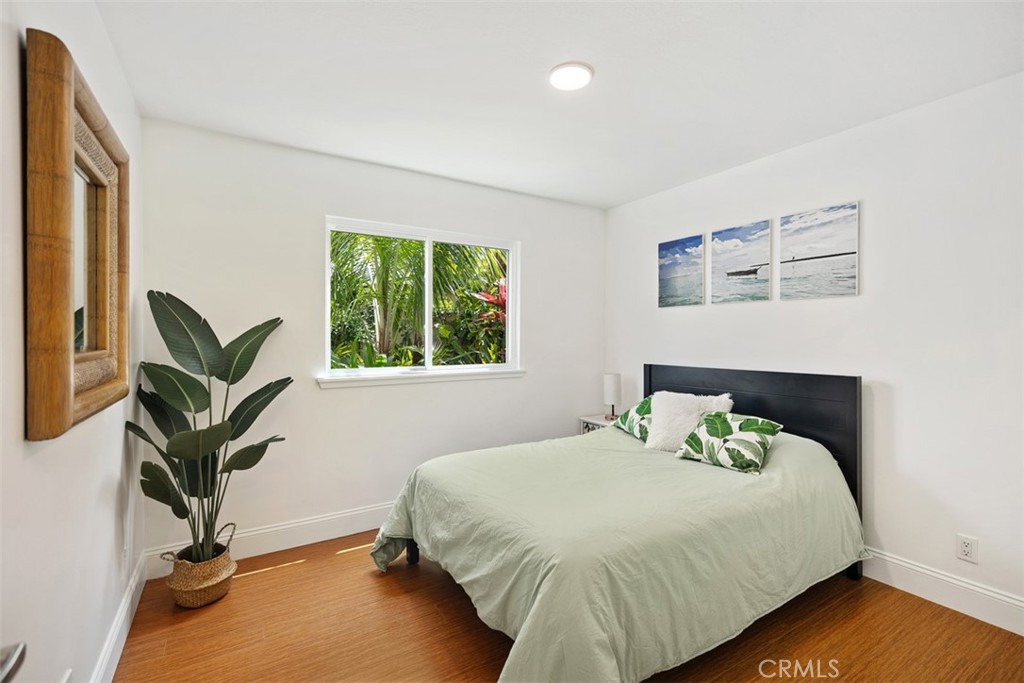 11596 Lakia Drive Cypress, CA 90630 - Photo 22 of 46 a bedroom with a bed and a potted plant on the dresser