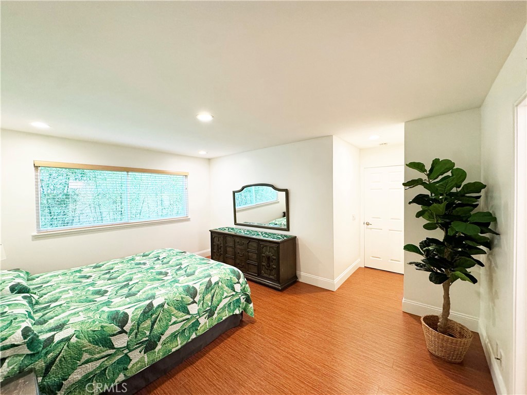 11596 Lakia Drive Cypress, CA 90630 - Photo 28 of 46 a bedroom with a bed dresser and a window
