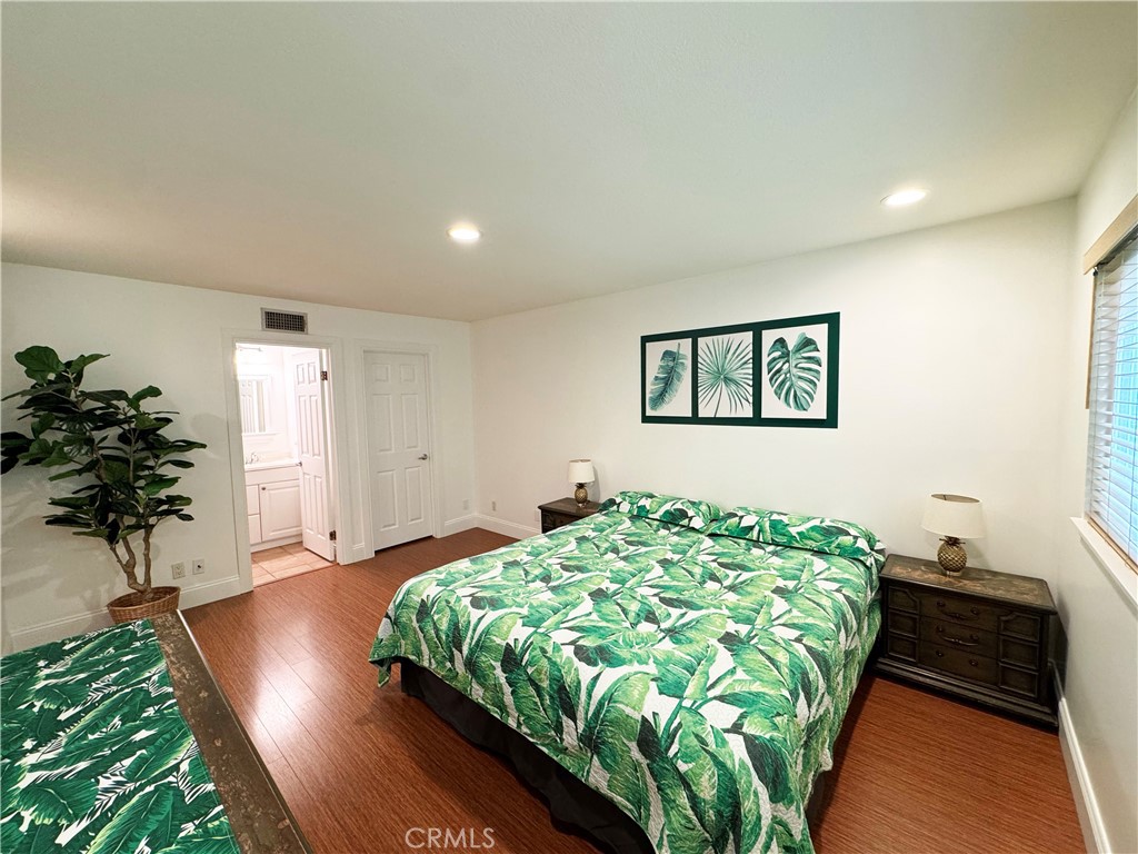 11596 Lakia Drive Cypress, CA 90630 - Photo 32 of 46 a bedroom with bed and a potted plant