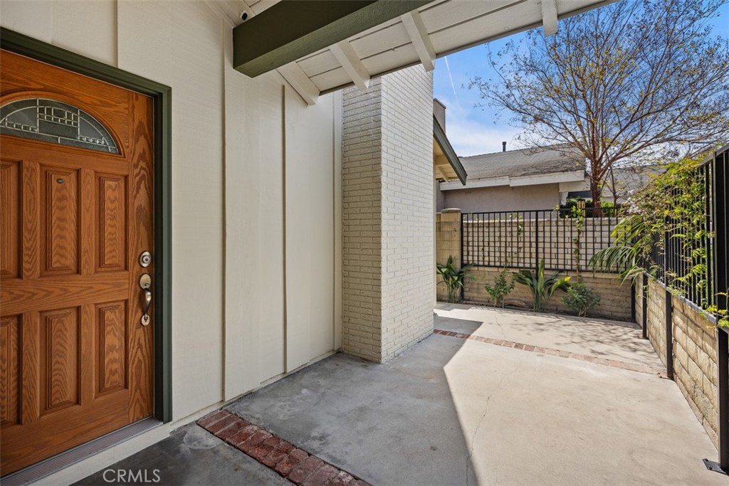 11596 Lakia Drive Cypress, CA 90630 - Photo 6 of 46 a view of a house with a wooden bench in front of door