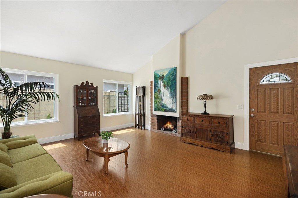 11596 Lakia Drive Cypress, CA 90630 - Photo 8 of 46 a living room with furniture and a fireplace