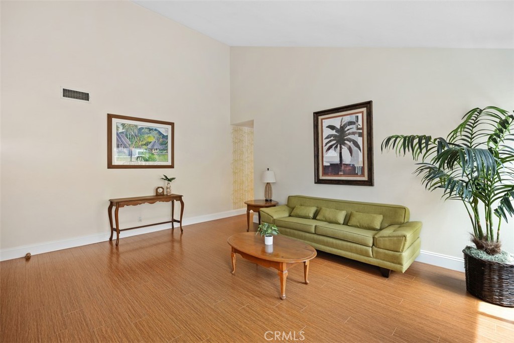11596 Lakia Drive Cypress, CA 90630 - Photo 9 of 46 a living room with furniture and a potted plant