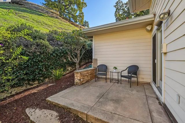 a backyard of a house with table and chairs