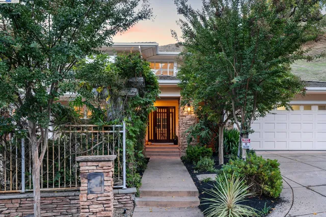 a view of house with outdoor space and trees