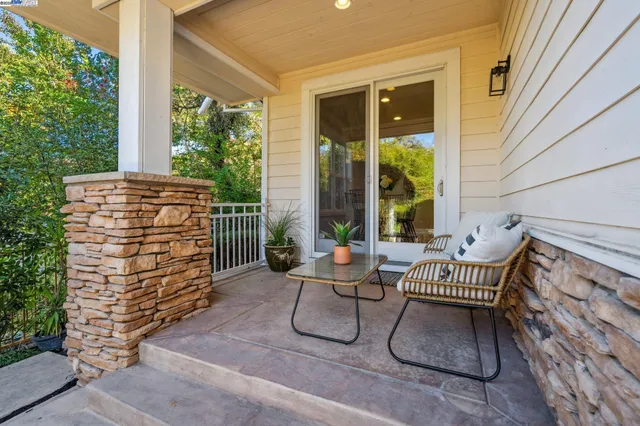 a view of a patio with table and chairs and potted plants