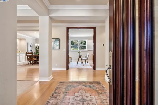a view of a big room with wooden floor and windows