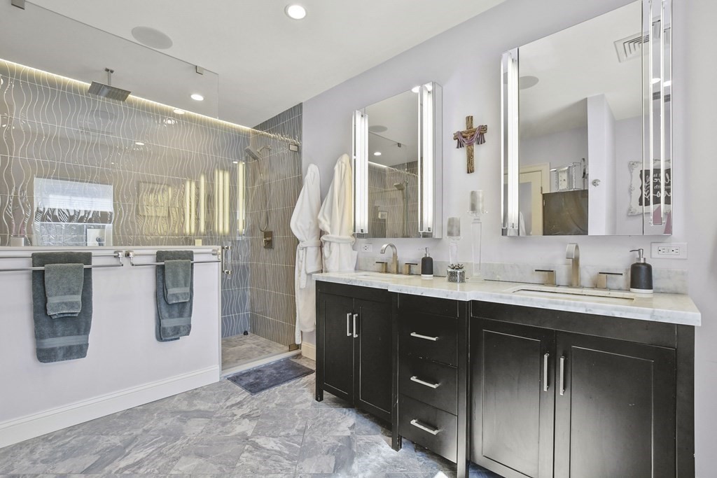61 Court Road Braintree, MA 02184 - Photo 19 of 42 a spacious bathroom with a double vanity sink a mirror and a shower