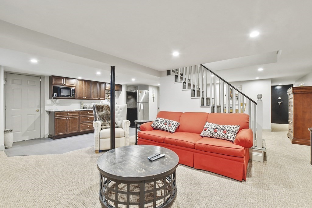 61 Court Road Braintree, MA 02184 - Photo 27 of 42 a living room with furniture kitchen view and a wooden floor