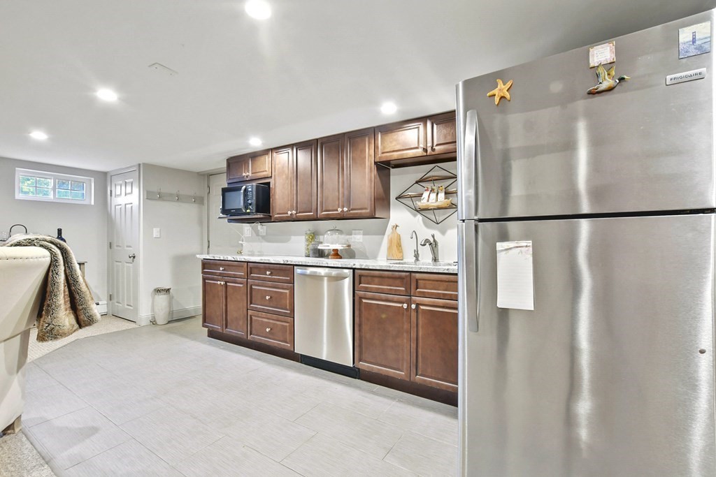 61 Court Road Braintree, MA 02184 - Photo 28 of 42 a kitchen with stainless steel appliances a refrigerator sink microwave and cabinets