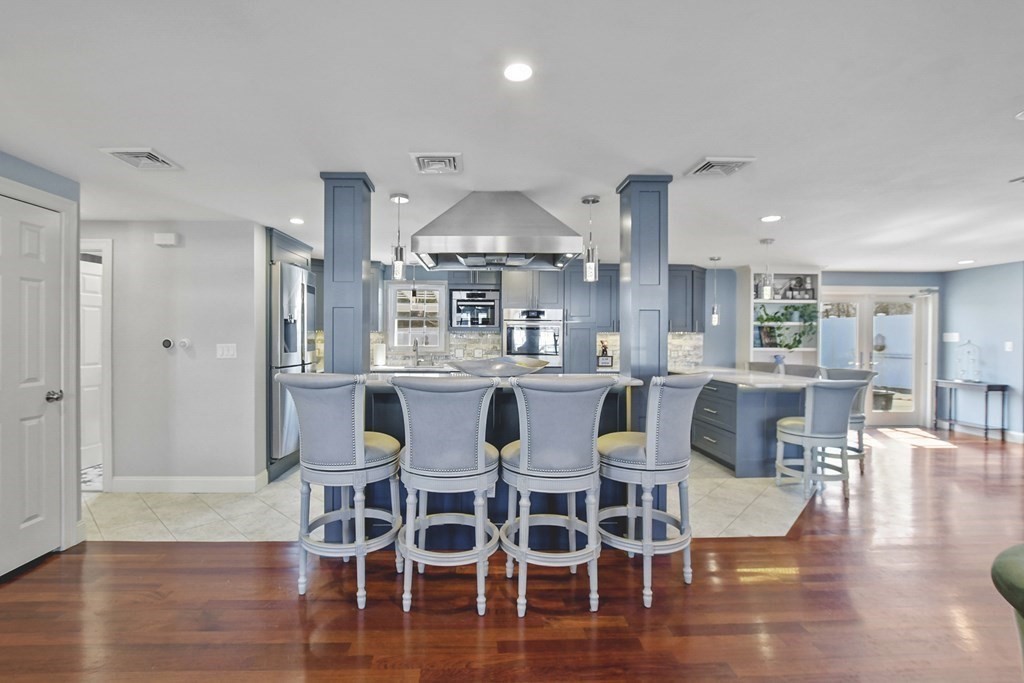 61 Court Road Braintree, MA 02184 - Photo 4 of 42 a dining room with wooden floor a glass table and chairs