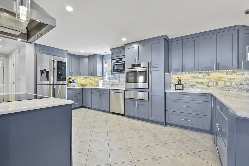 61 Court Road Braintree, MA 02184 - Photo 8 of 42 a kitchen with kitchen island cabinets and oven