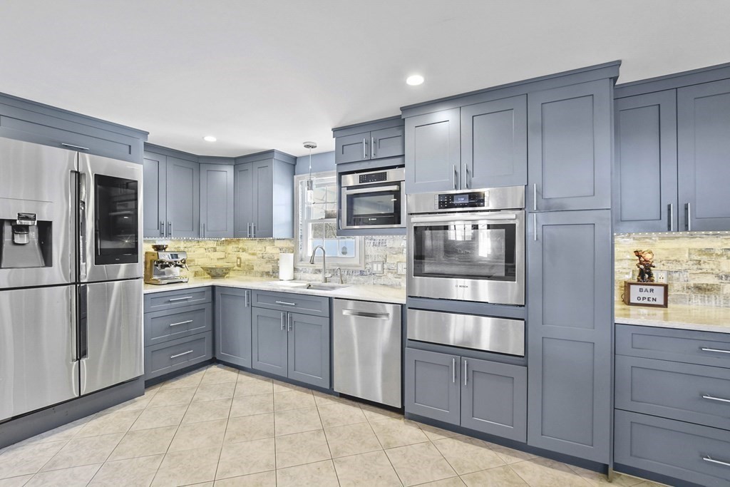 61 Court Road Braintree, MA 02184 - Photo 9 of 42 a kitchen with granite countertop stainless steel appliances and refrigerator