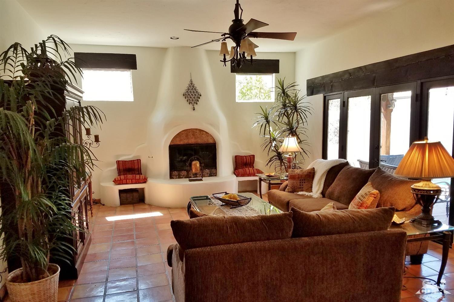 52225 Avenida Obregon La Quinta, CA 92253 - Photo 11 of 34 a living room with furniture and a fireplace