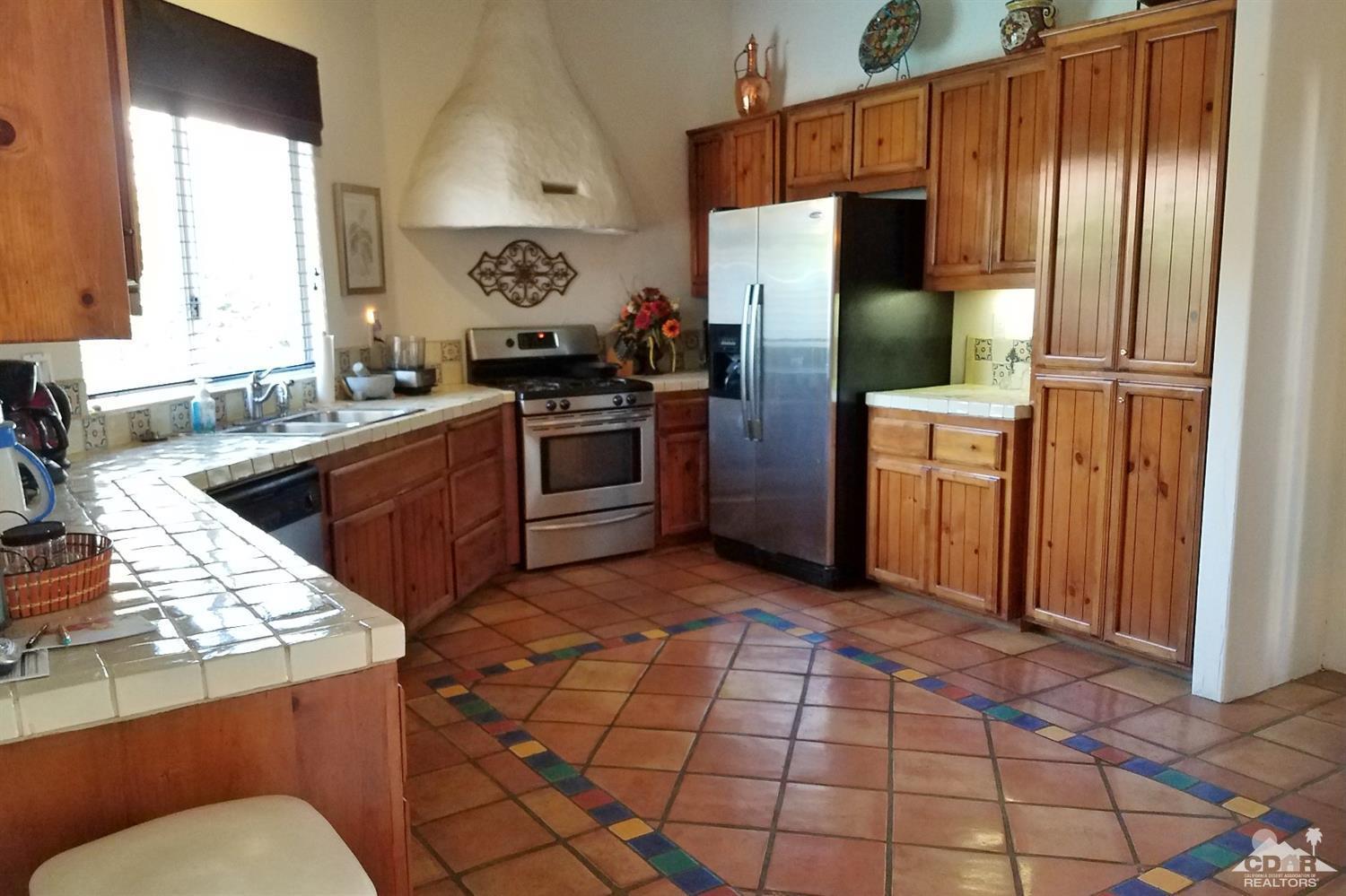 52225 Avenida Obregon La Quinta, CA 92253 - Photo 18 of 34 a kitchen with stainless steel appliances granite countertop a refrigerator and a sink