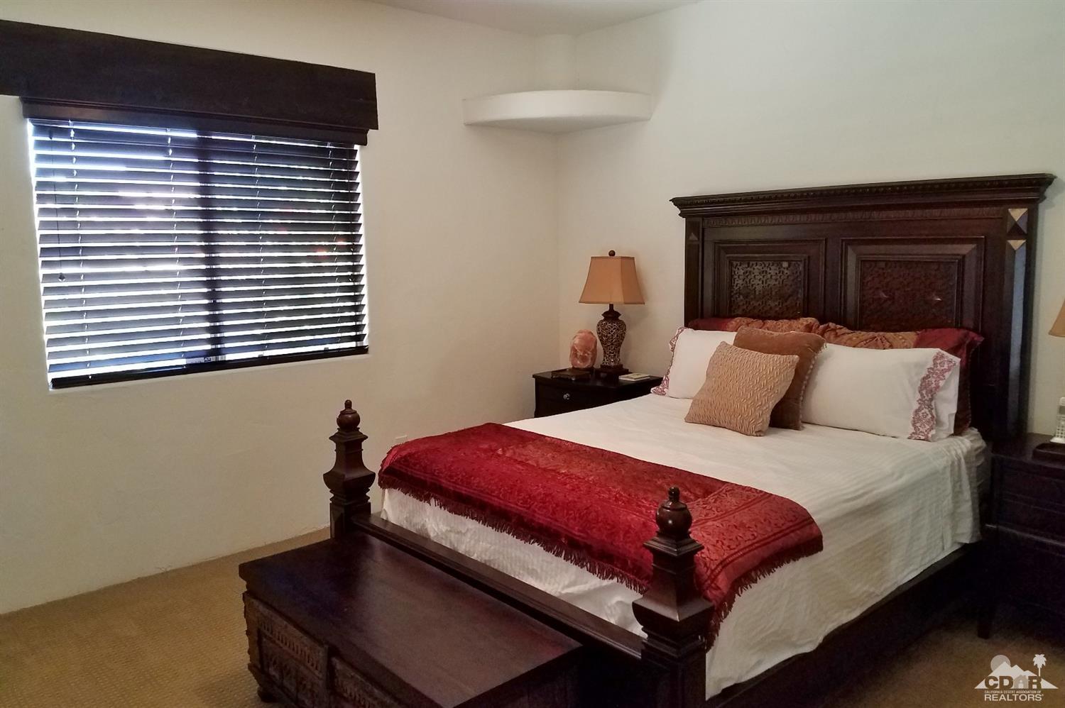 52225 Avenida Obregon La Quinta, CA 92253 - Photo 22 of 34 a bedroom with a bed and a window