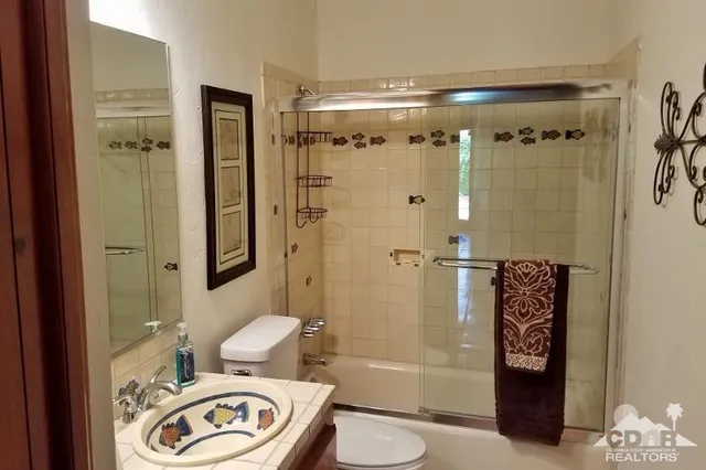 a bedroom with a bed and a mirror