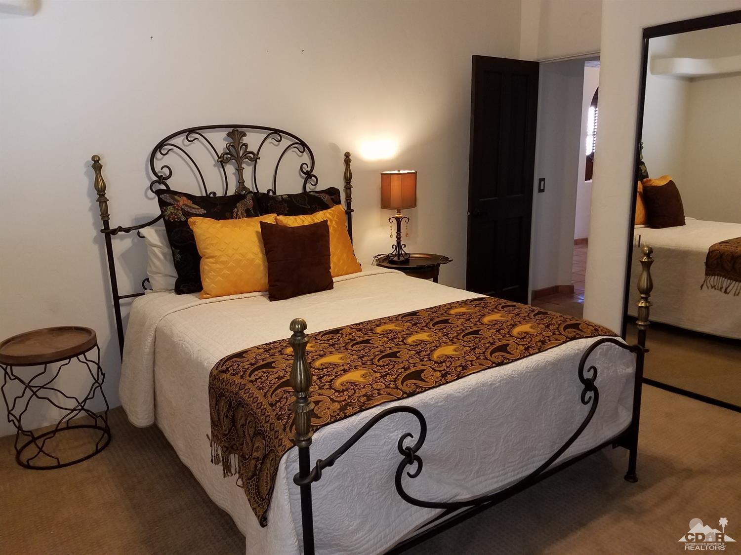 52225 Avenida Obregon La Quinta, CA 92253 - Photo 25 of 34 a bed sitting in a bedroom next to a window