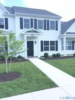 a view of a house with a yard and sitting space