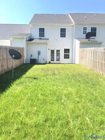 a view of a house with backyard and a garden