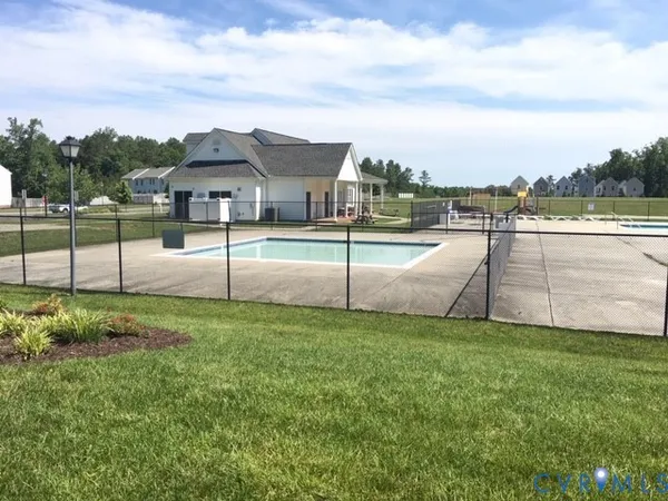 a view of a house with a yard and sitting area