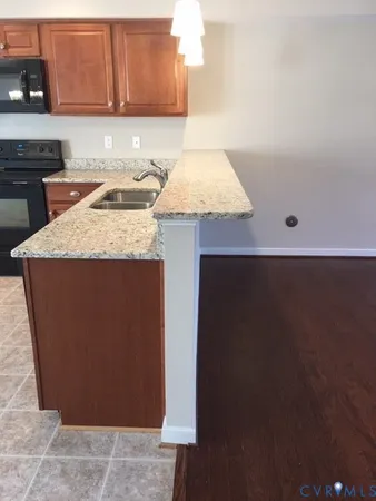 a kitchen with a sink a stove and cabinets