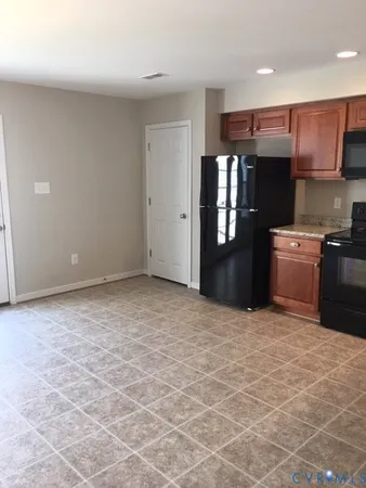 a kitchen with stainless steel appliances granite countertop a stove refrigerator sink and cabinets