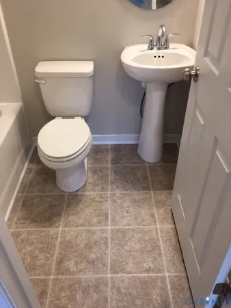 a bathroom with a sink toilet and mirror