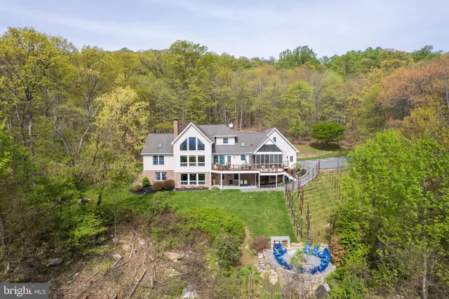 a front view of a house with a yard and trees