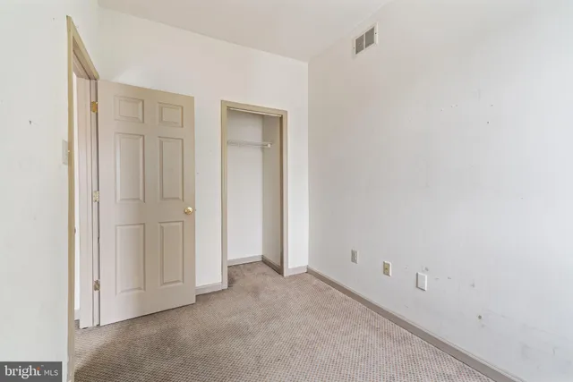 a bedroom with bed tv and window