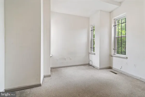 a room with a sink a vanity and window
